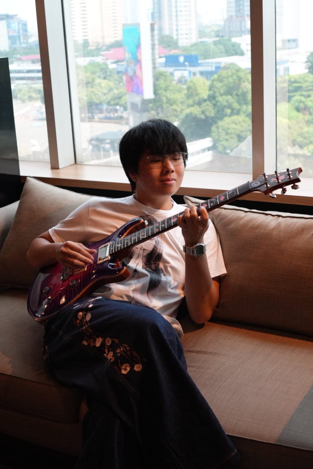 Jayden performing or playing guitar